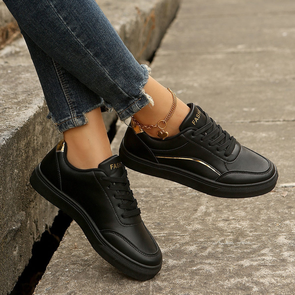 Women’s white round-toe flats with thick sole, casual lace-up style.