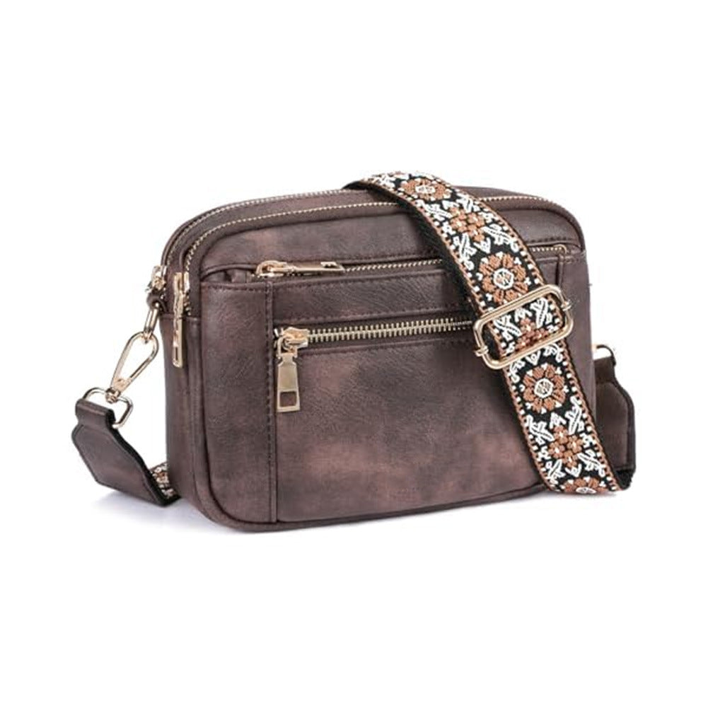 Women’s triple-zip colorblock crossbody bag with embroidered strap.