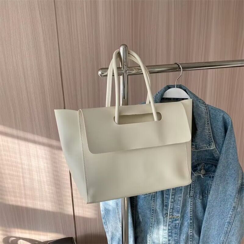 Women’s large retro tote handbag, simple solid-color design.