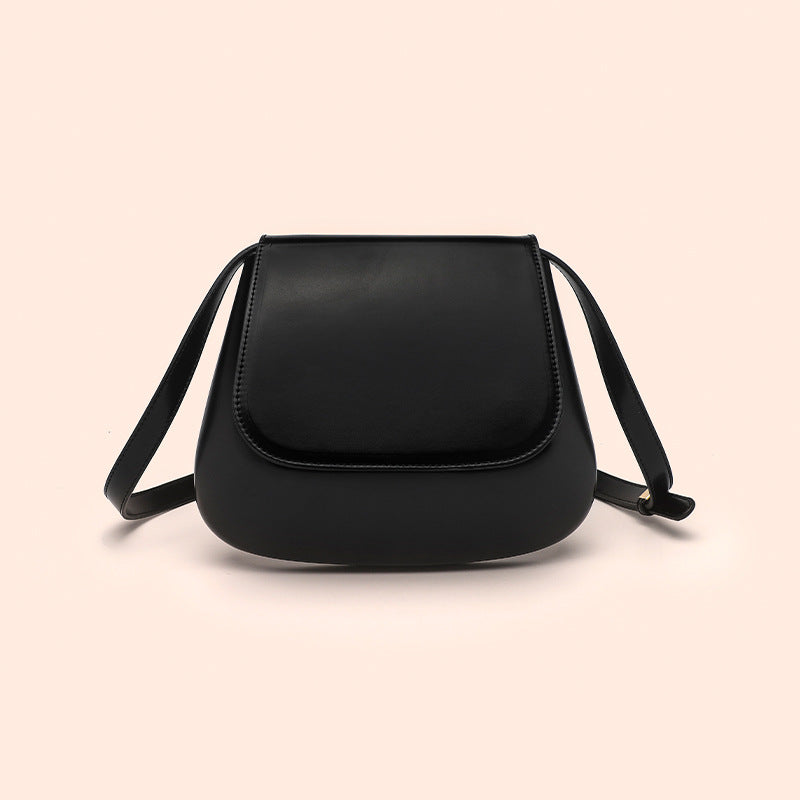 Women’s vegan leather retro saddle crossbody bag with adjustable strap.