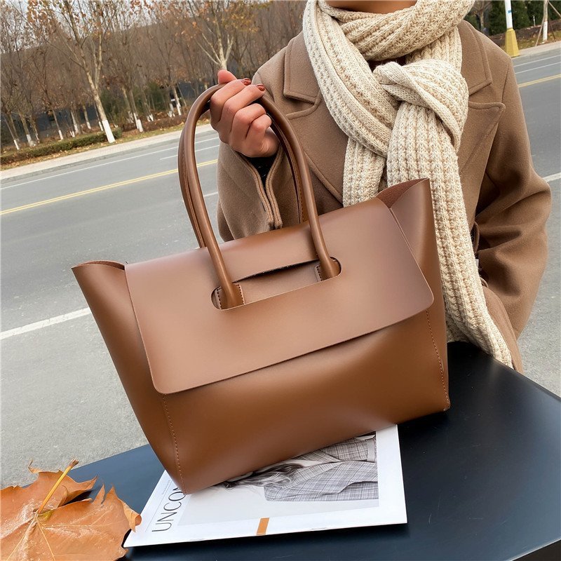 Women’s large retro tote handbag, simple solid-color design.