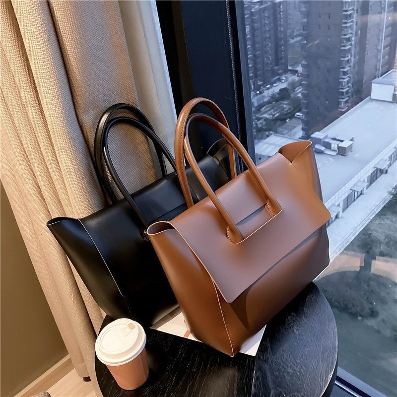 Women’s large retro tote handbag, simple solid-color design.