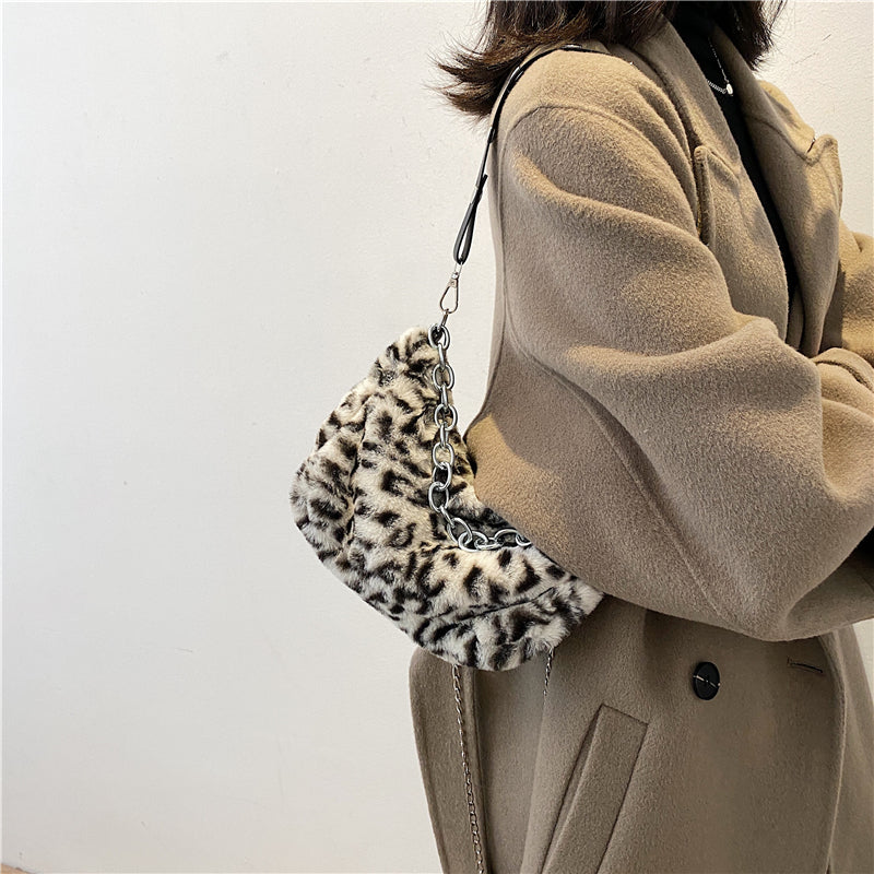 Women’s leopard print shoulder bag with chain strap.