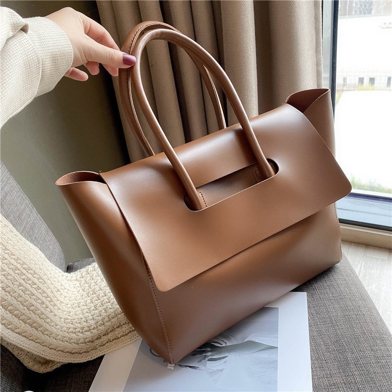 Women’s large retro tote handbag, simple solid-color design.