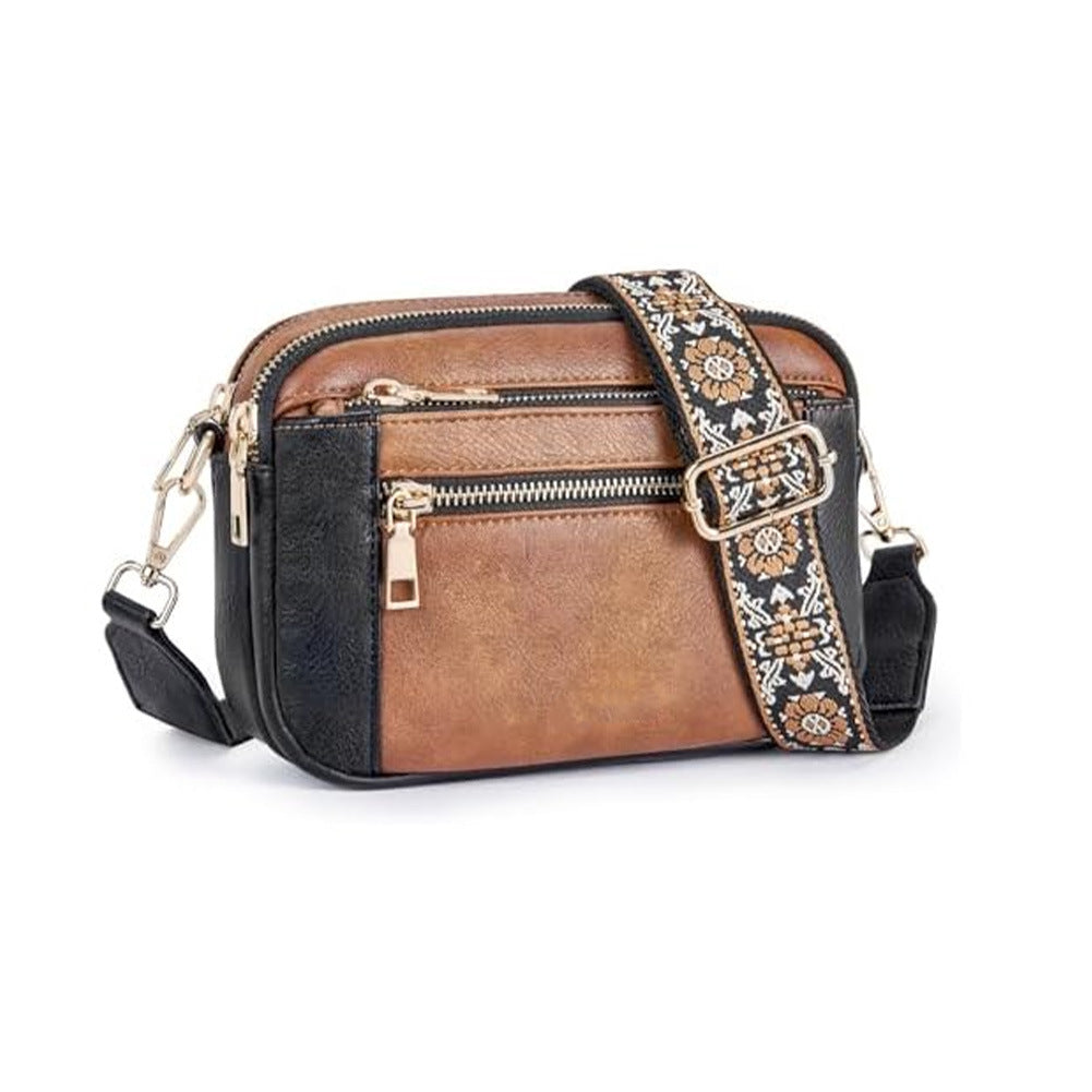 Women’s triple-zip colorblock crossbody bag with embroidered strap.