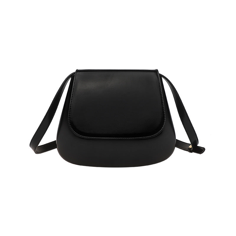 Women’s vegan leather retro saddle crossbody bag with adjustable strap.