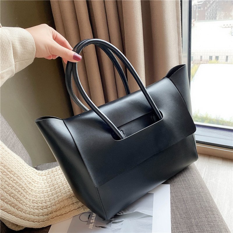 Women’s large retro tote handbag, simple solid-color design.