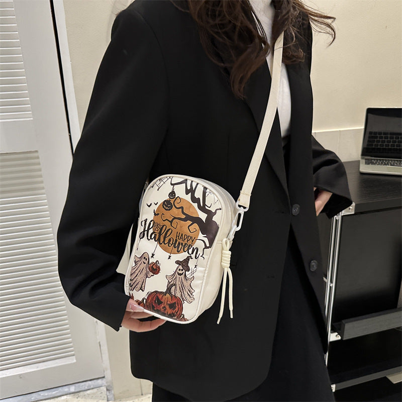 Mini Halloween cartoon crossbody bag with pumpkin, ghost, and bat print.
