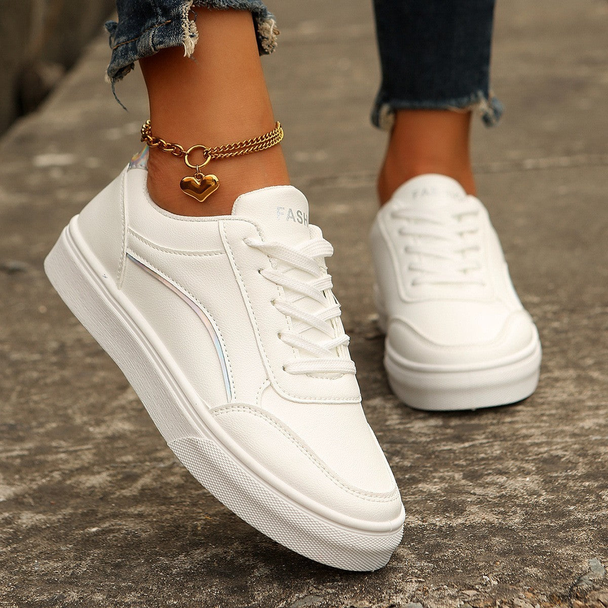 Women’s white round-toe flats with thick sole, casual lace-up style.