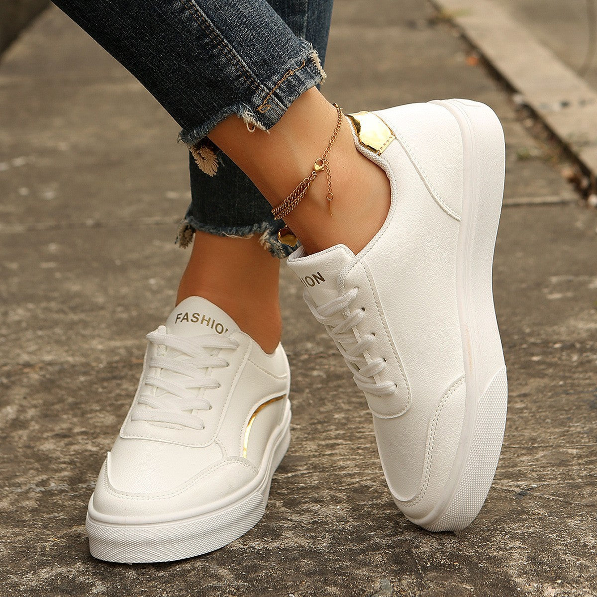 Women’s white round-toe flats with thick sole, casual lace-up style.