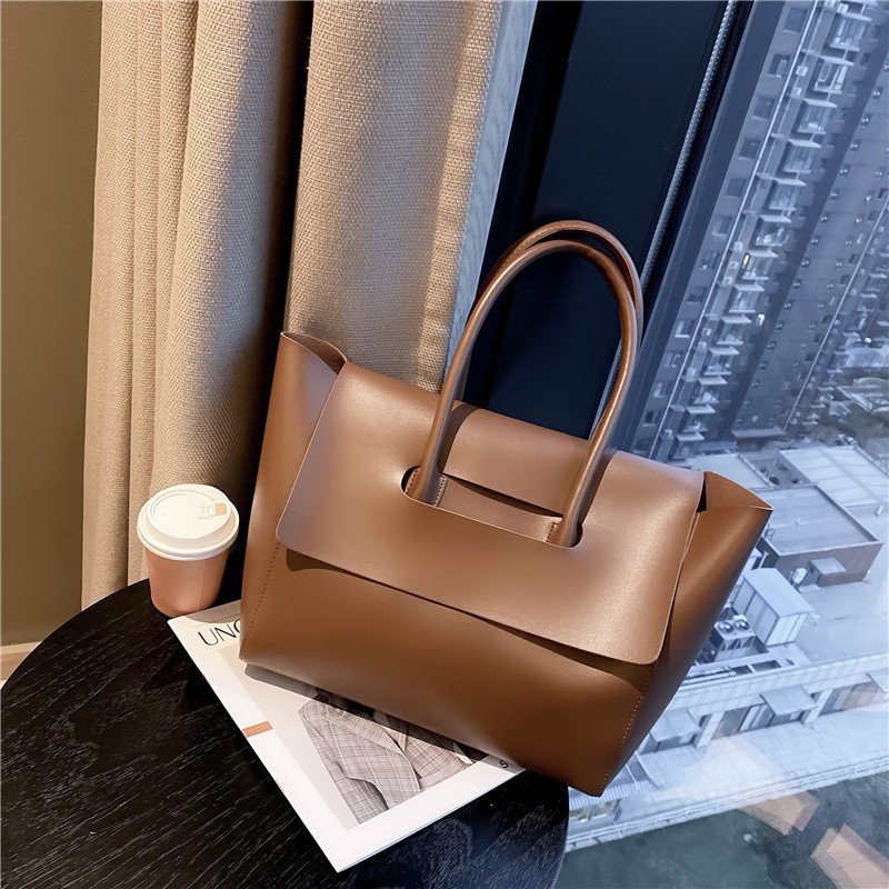 Women’s large retro tote handbag, simple solid-color design.
